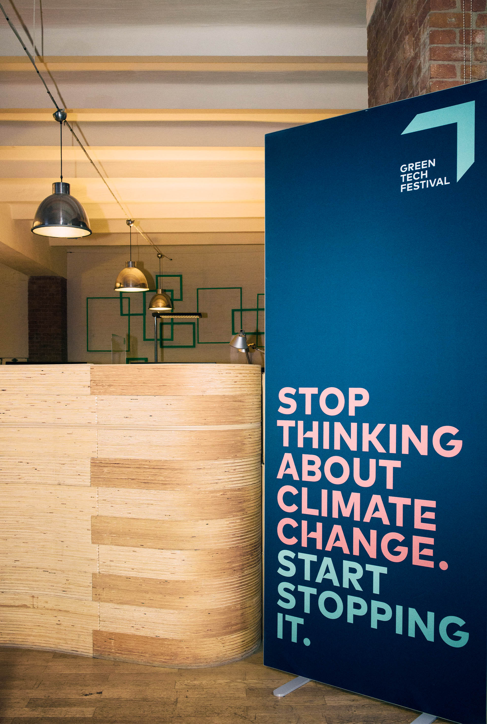 A stand-up display reading, “Stop thinking about climate change. Start stopping it.”