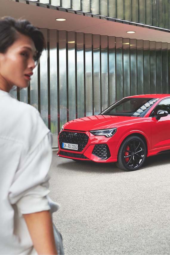 Audi Rs Q3 Sportback side front view with a woman
