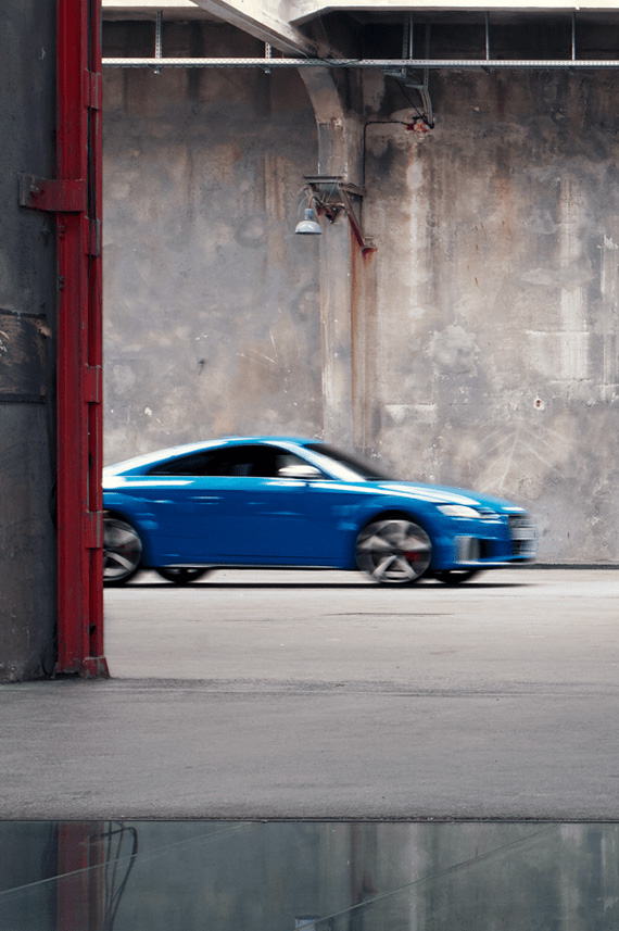 Audi TTS Coupé blurry in the back of a fabric hall